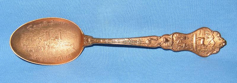 C & A Shaft.JPG - SOUVENIR MINING SPOON C & A SHAFT BISBEE ARIZONA - Copper souvenir spoon, circa 1900, embossed mining scene in bowl with C. and A. Shaft above and Bisbee, Ariz. below, handle finial with Arizona territorial seal and ARIZONA on the handle, fancy design on handle reverse, 5 1/4 in. long [Although Phelps Dodge, owner and operator of the famous Copper Queen mine, was the largest mining company in Bisbee, Arizona it was not the only one. The Calumet and Arizona (C&A) Mining Company, organized in March 1901 with Charles Briggs as president, operated several large and profitable mines, principal among them the Irish Mag mine, adjacent to the Copper Queen.  By 1907, the C&A was the fourth-most productive copper mine in Arizona, and ran its own smelter in Douglas, Arizona. In 1911, the company merged with the Superior and Pittsburg Copper Company ultimately buying out Superior and Pittsburg in 1915.  The original C&A mine included 12 claims and 178 patented acres adjoining the Copper Queen.  With John C. Greenway as general manager, the company expanded operations to include the Irish Mag shaft to a depth of 1350 feet, the Ontario shaft to a depth of 1450 feet, the Powell shaft to 600 feet deep, the Hoatson shaft to 1530 feet deep and the Junction shaft to 1837 feet deep.  By 1910 the C&A employed 1274 men, 805 at the mine and 469 at the smelter.  In 1915 copper production exceeded 65 million pounds and by 1916, the company controlled over 2000 acres of mining property within the Warren Mining District.  The C&A was the first mine in Arizona to discontinue work on Sundays effective August 1910. The company’s fortunes took a turn for the worse in the 1920s and with the company failing, Phelps Dodge bought out their old nemesis in September 1931.]  